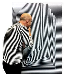 Volker Pook looking at a poster with stripes